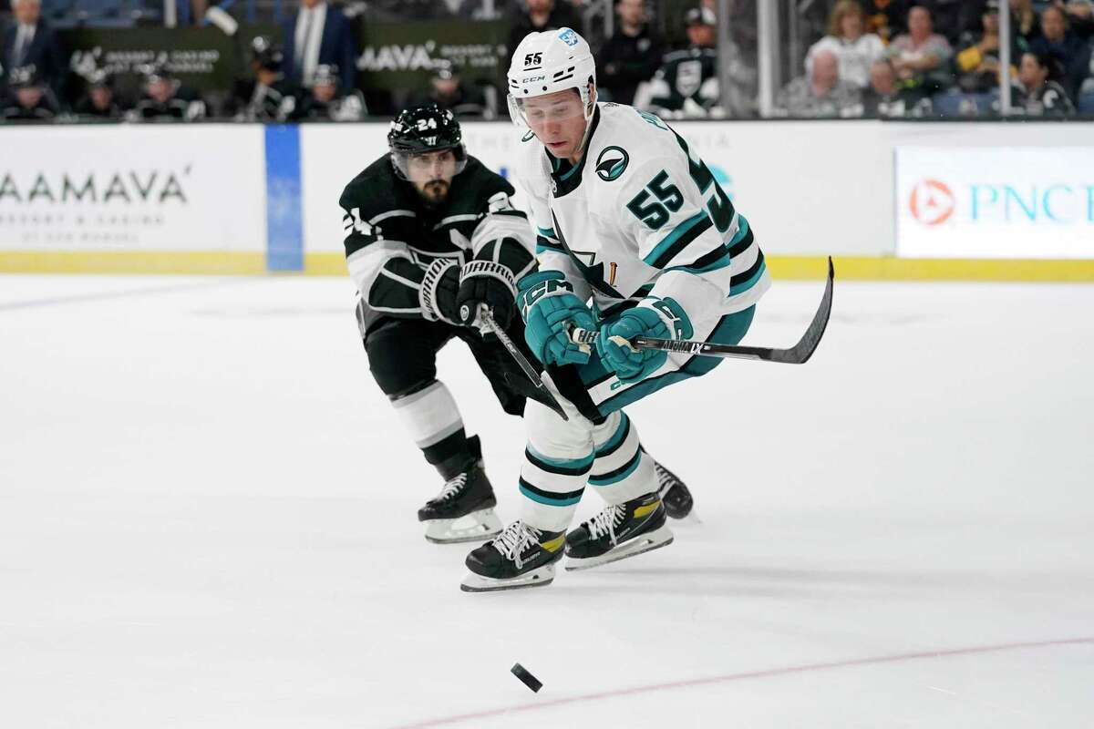 San Jose Sharks' Sasha Chmelevski, right, moves the puck while under pressure from Los Angeles Kings' Phillip Danault during the second period of a preseason NHL hockey game Wednesday, Sept. 28, 2022, in Ontario Calif. (AP Photo/Mark J. Terrill)