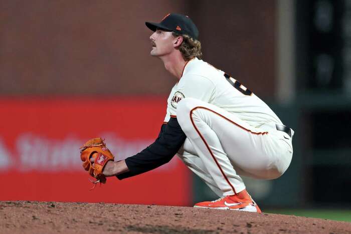 Giants catchers work on the back pick, a favorite Buster Posey play