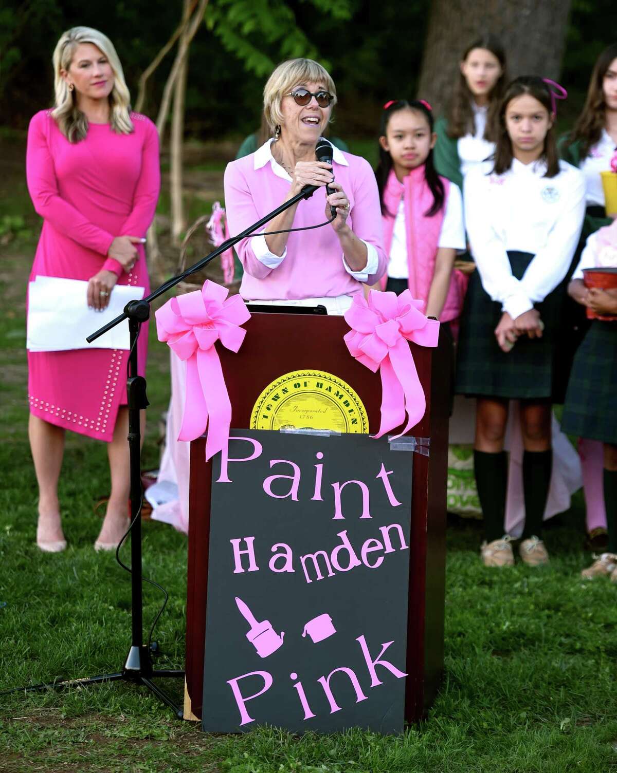 Breast cancer survivor Sheila Malony, professor of nursing at Quinnipiac University, speaks at the dedication of a memorial garden for those lost to breast cancer in Hamden Town Center Park on September 28, 2022 that included the unveiling of a granite bench
