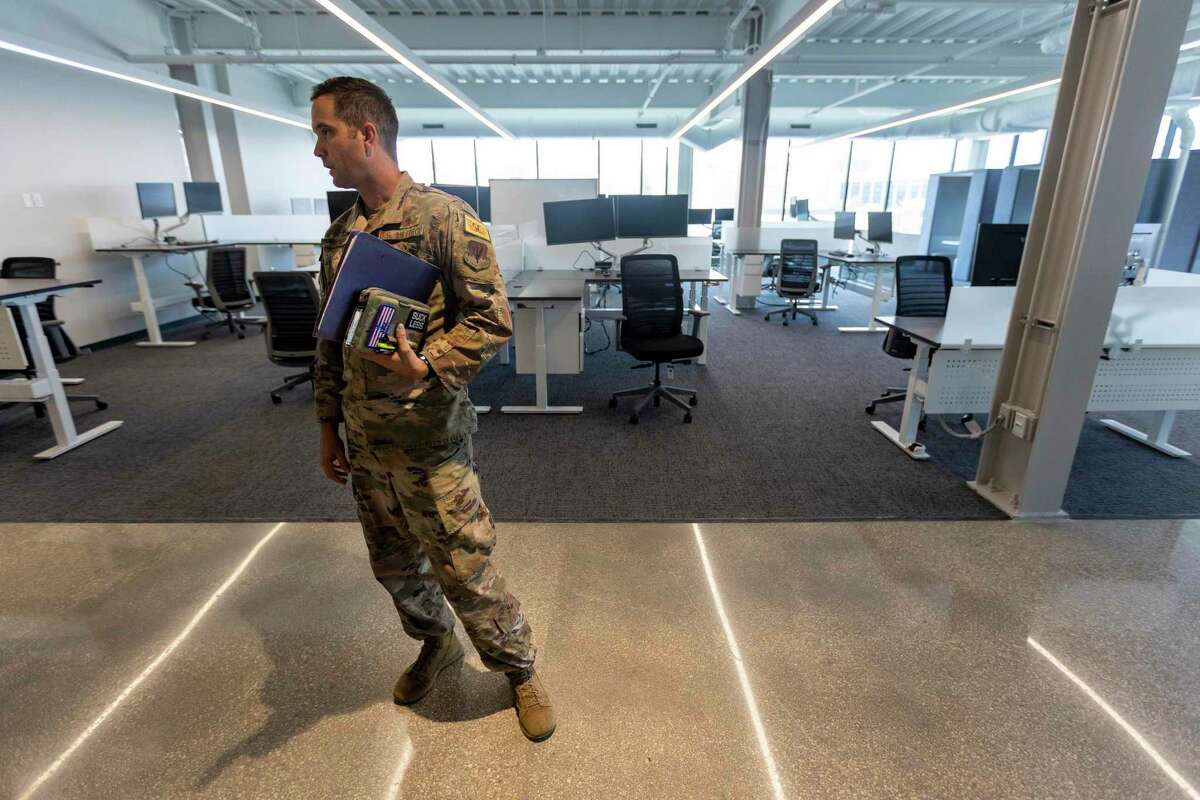Lt. Col. Casey Miller, commander of the U.S. Air Force’s 90th Cyberspace Operations Squadron, tours the unit’s new software development office in the Light Building in downtown San Antonio.