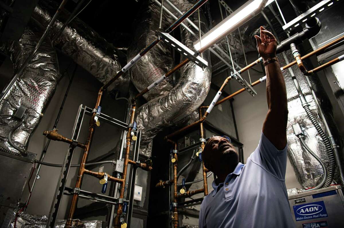 Facilities Manager Rod Turner (57) gives journalists a tour of the Geothermal HVAC system that heats and cools the new Houston Endowment building, on Monday, September 26, 2022 in Houston, TX. It is one of only a handful of commercial buildings in the city to implement a geothermal HVAC, which is significantly more efficient compared to a traditional HVAC unit. It works by utilizing 35 geothermal wells, dug 300 feet deep. (Meridith Kohut / For the Houston Chronicle)