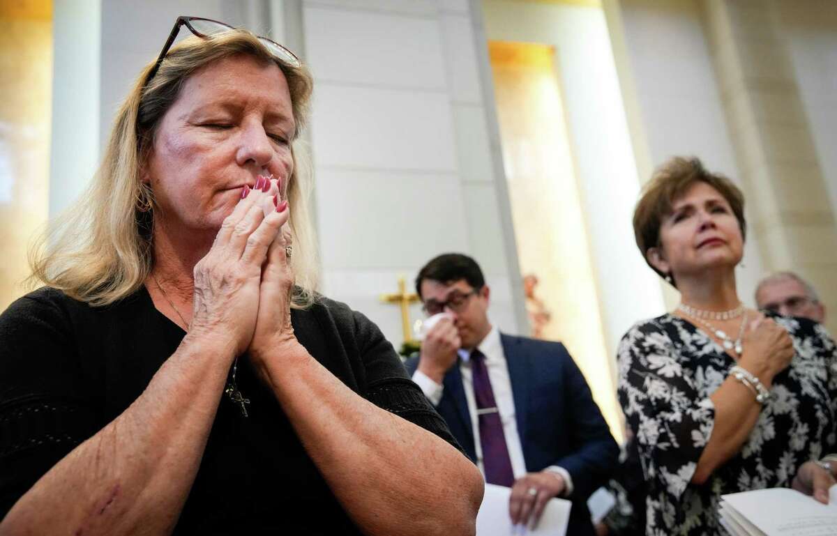 Sally Flowers prays as Archbishop Emeritus Joseph Fiorenza’s casket is brought in during his funeral Mass Thursday at the Co-Cathedral of the Sacred Heart in Houston. Fiorenza died Sept. 19 at 91. “I just feel very blessed that I was able to be a part of the funeral today,” Flowers said. “I feel like God called me here.”
