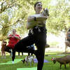 Gracee Buesing does a tree pose while cradling a goat as Lamar students enjoy goat yoga amid a week of fun, quirky and spirited homecoming events began Monday. Photo made Thursday, September 29, 2022 Kim Brent/Beaumont Enterprise