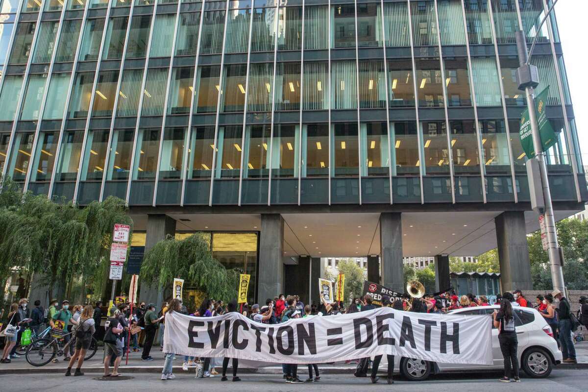 A crowd of tenant activists and supporters who gathered to push for lasting renter protections stand outside of One Bush Street building in San Francisco during an event "Bay Area Action to Stop Pandemic Evictions!" on Wednesday, September 29, 2021.