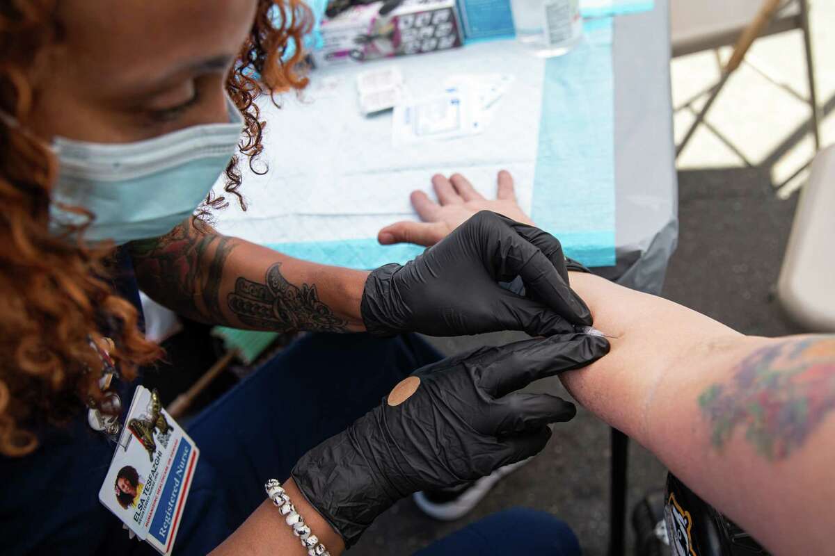 Elsa Tesfazghi, registered nurse, administers a monkeypox vaccine to an attendee of the annual Folsom Street Fair. On Sunday, September 25, 2022 in San Francisco, California.