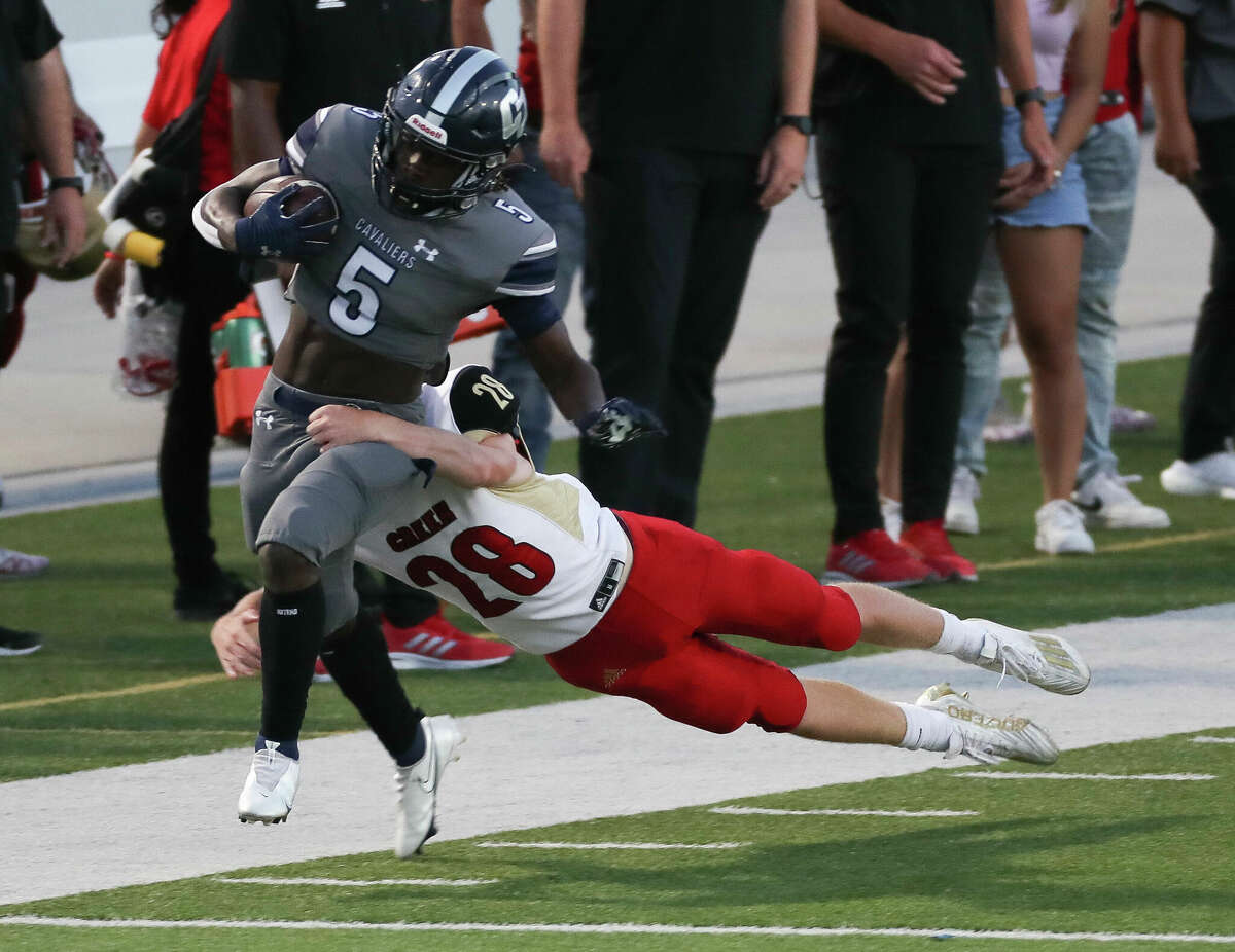 College Park running back Eugene (5) is brought down by Caney Creek outside linebacker Michael Stewart (28) after a 42-yard gain in the first quarter of a District 13-6A high school football game at Woodforest Bank Stadium, Thursday, Sept. 29, 2022, in Shenandoah.