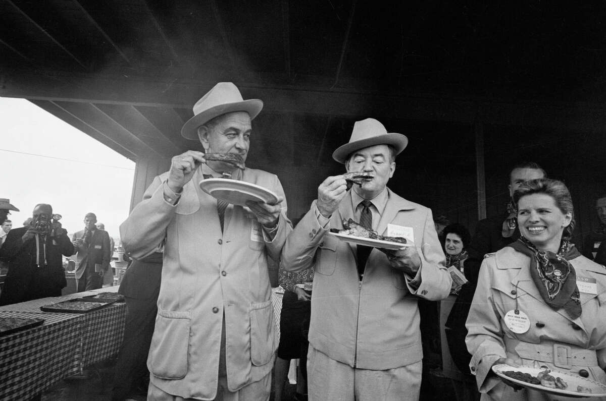 President Lyndon B. Johnson (left) and Vice President Elect Hubert Humphrey enjoy barbecue spareribs at a victory celebration at the LBJ Ranch on Nov. 4, 1964, in Johnson City, Texas.