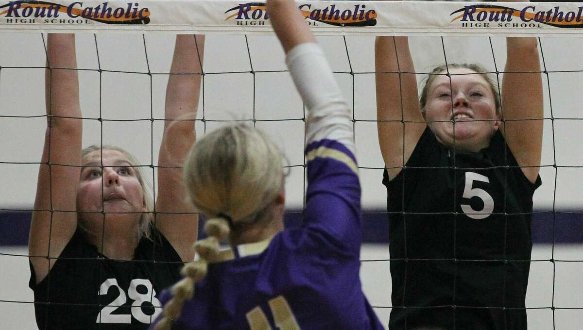 West Central's Gracie Moore (left) and Bell Brown reach for the ball during a volleyball match against Routt at the Routt Dome in Jacksonville Thursday night.