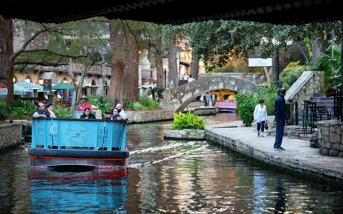 People enjoy the San Antonio River Walk through downtown on Tuesday, Jan. 18, 2022. 