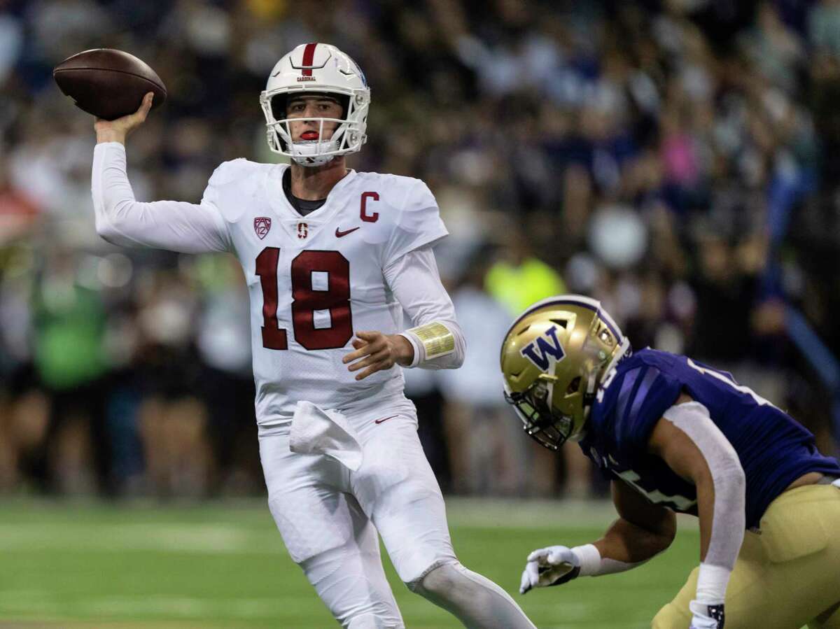 Stanford quarterback Tanner McKee attempts to throw a pass while being pressured by Washington linebacker Daniel Heimuli during the first half of an NCAA college football game Saturday, Sept. 24, 2022, in Seattle. (AP Photo/Stephen Brashear)