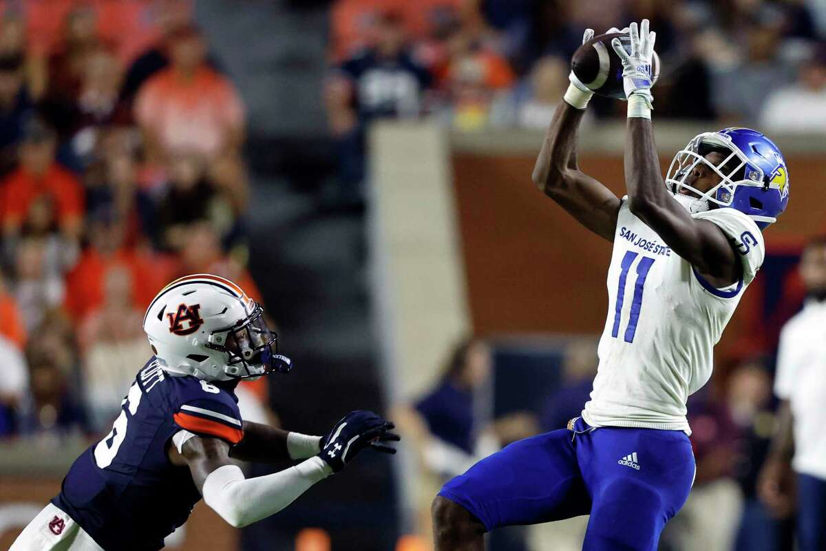 San Jose State wide receiver Justin Lockhart (11) catches a pass as Auburn cornerback Keionte Scott (6) defends during the second half of an NCAA college football game Saturday, Sept. 10, 2022, in Auburn, Ala. (AP Photo/Butch Dill)