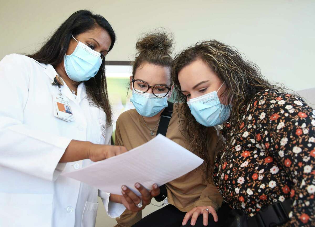 Pulmonary Hypertension Specialist Bindu Akkanti, of UTHealth Houston Heart & Vascular at Memorial Hermann-Texas Medical Center, talks to her patients and twin sister Brooke Garcia, right, and Briana Saenz during their check-up appointment. The twin sisters have family history of pulmonary hypertension,.
