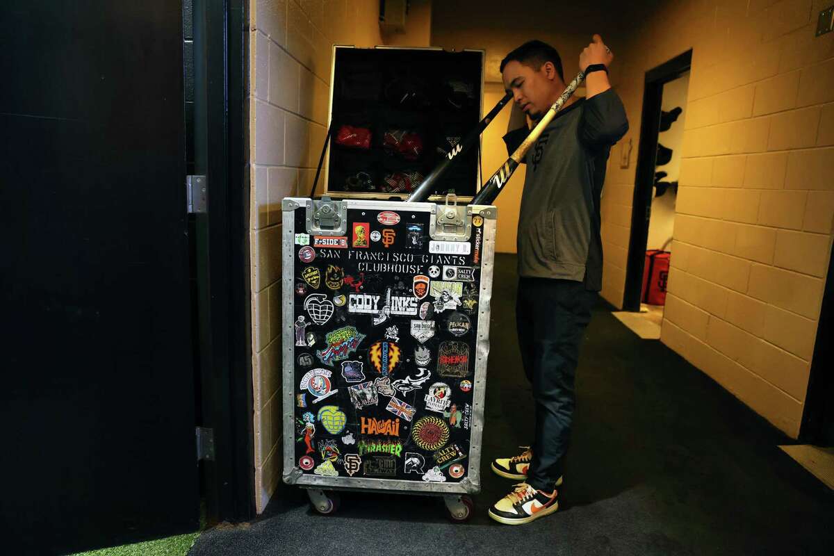 San Francisco Giants clubhouse assistant Austin Ginn rearranged items in the bat trunk before Giants play Colorado Rockies in MLB game at Oracle Park in San Francisco, Calif., on Wednesday, September 28, 2022.