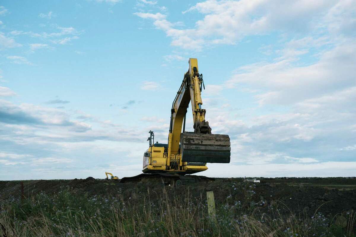 View of the Elk River restoration project in Eureka, Calif. on Sep 19, 2022. An excavator creates a berm next to the freeway. This section of the project is converting pastureland into a salt marsh and intertidal channel network that will connect to the Elk River, reclaiming historic floodplain and providing capacity for king tides and resilience to sea level rise. The sea level is expected to rise 3 feet by 2060 in Humboldt Bay, the fastest rate on the West Coast. Worsened by tectonic activity, sea level rise threatens residences, stored waste from a decommissioned nuclear plant, wastewater treatment plants, and part of Highway 101 that connects Eureka and Arcata.