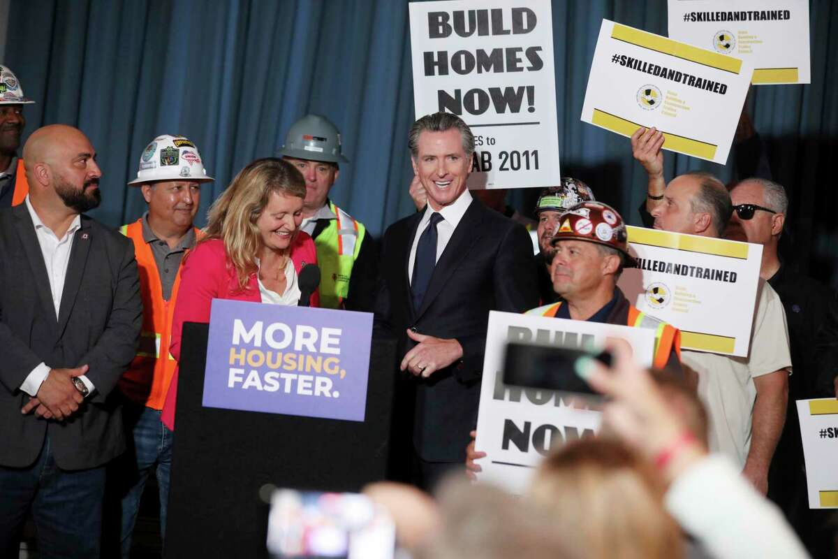 Gov. Gavin Newsom, center, stands with local and state officials at 4200 Geary Blvd., an affordable senior housing development, in San Francisco, Wednesday, Sept. 28, 2022. Newsom signed a legislative package to tackle California’s housing crisis.