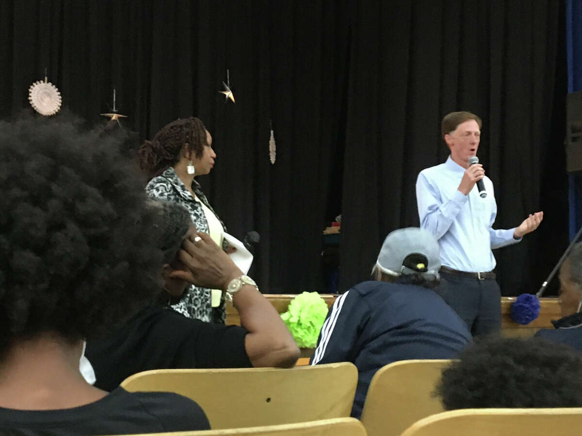 New Haven Mayor Justin Elicker speaks to members of Newhallville-Hamden Strong and neighbors in the Lincoln-Bassett Community School auditorium on Thursday, Sept. 29, 2022.