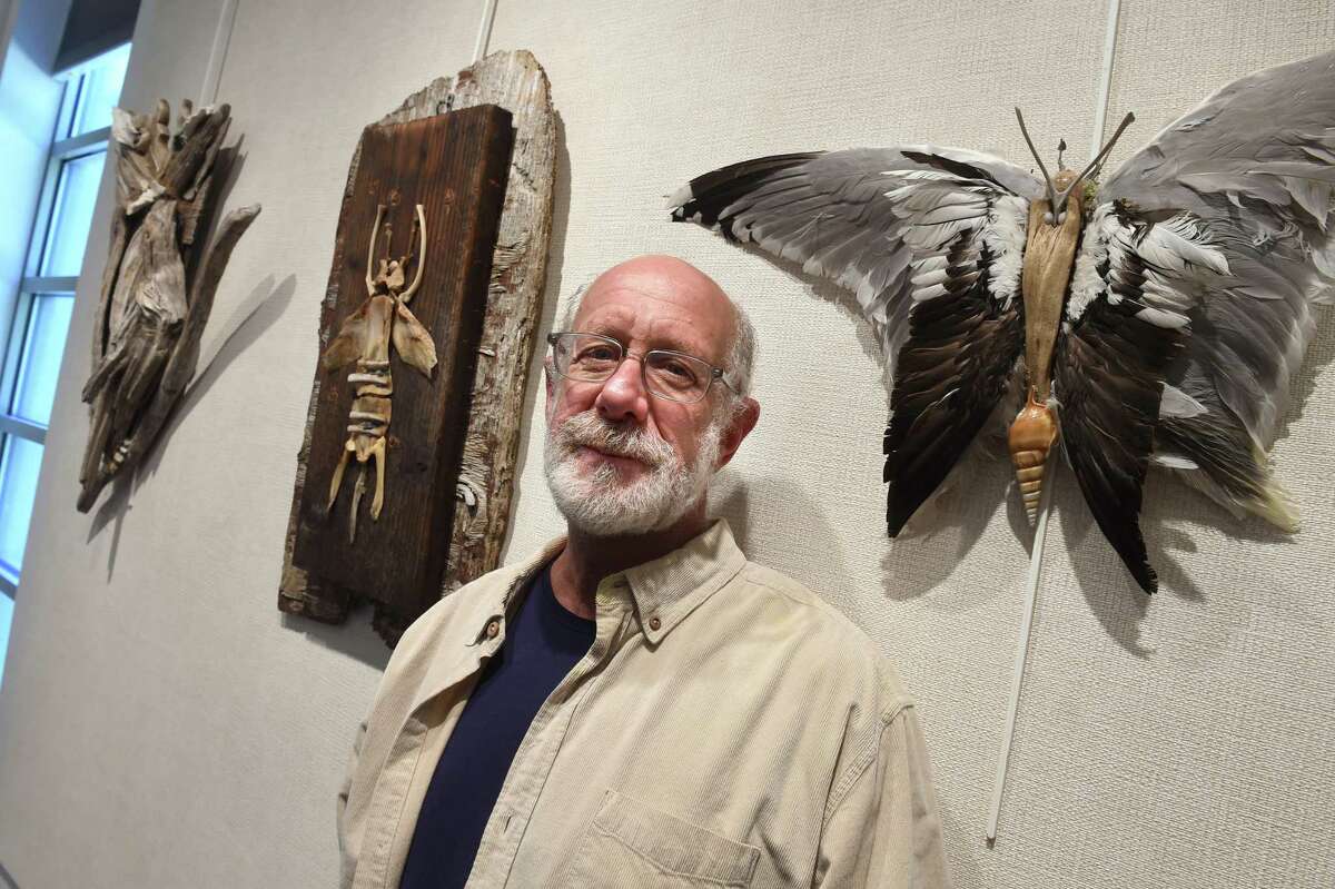 Alan Horwitz is photographed with some of his art created with found materials at an exhibit at the Willoughby Wallace Memorial Library in the Stony Creek section of Branford.