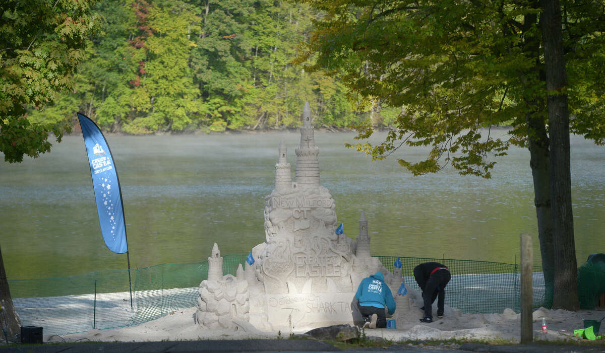 With Dan Anderson, right, of Dan in the Sand, Kevin Lane, of Create A Castle, has constructed a 15-foot sand castle at Lynn Deming Park in New Milford. They will appear in the Oct. 7th episode of "Shark Tank. Friday, September 30, 2022, New Milford, Conn.