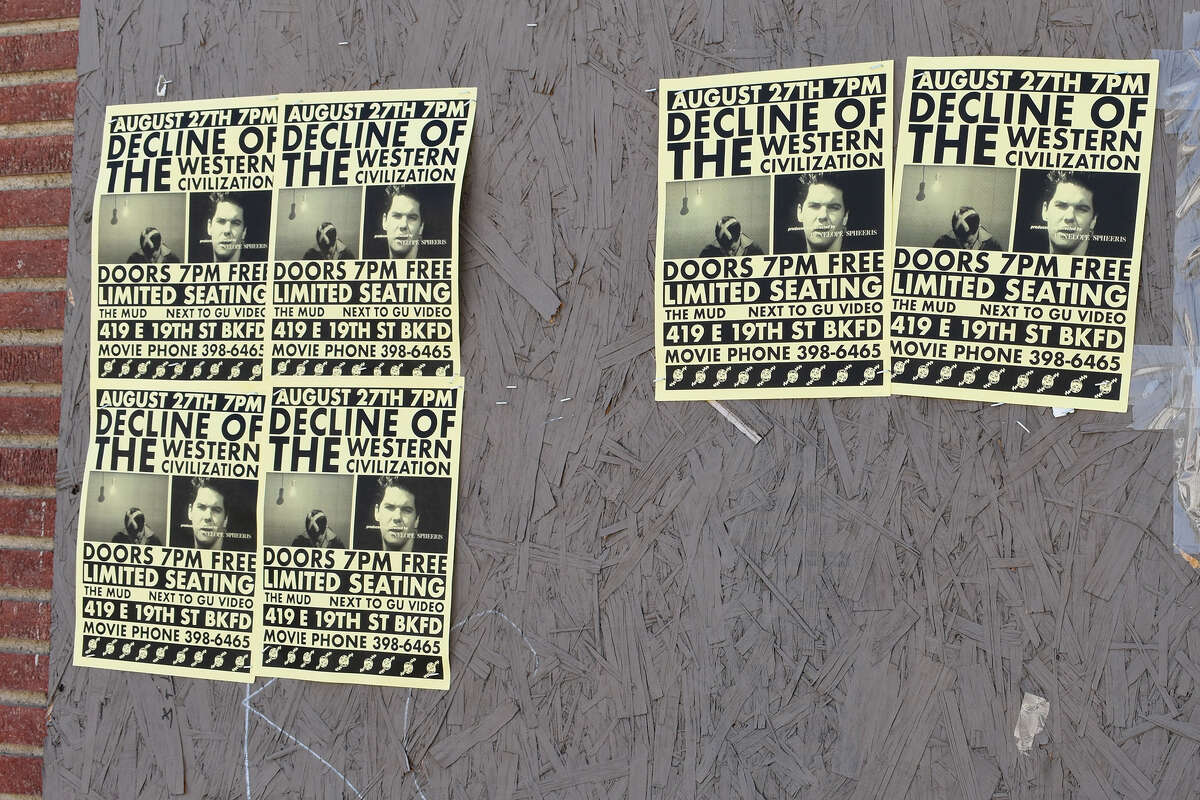 Flyers for Going Underground's showing of "The Decline of Western Civilization" plaster the walls of a boarded up east Bakersfield business.