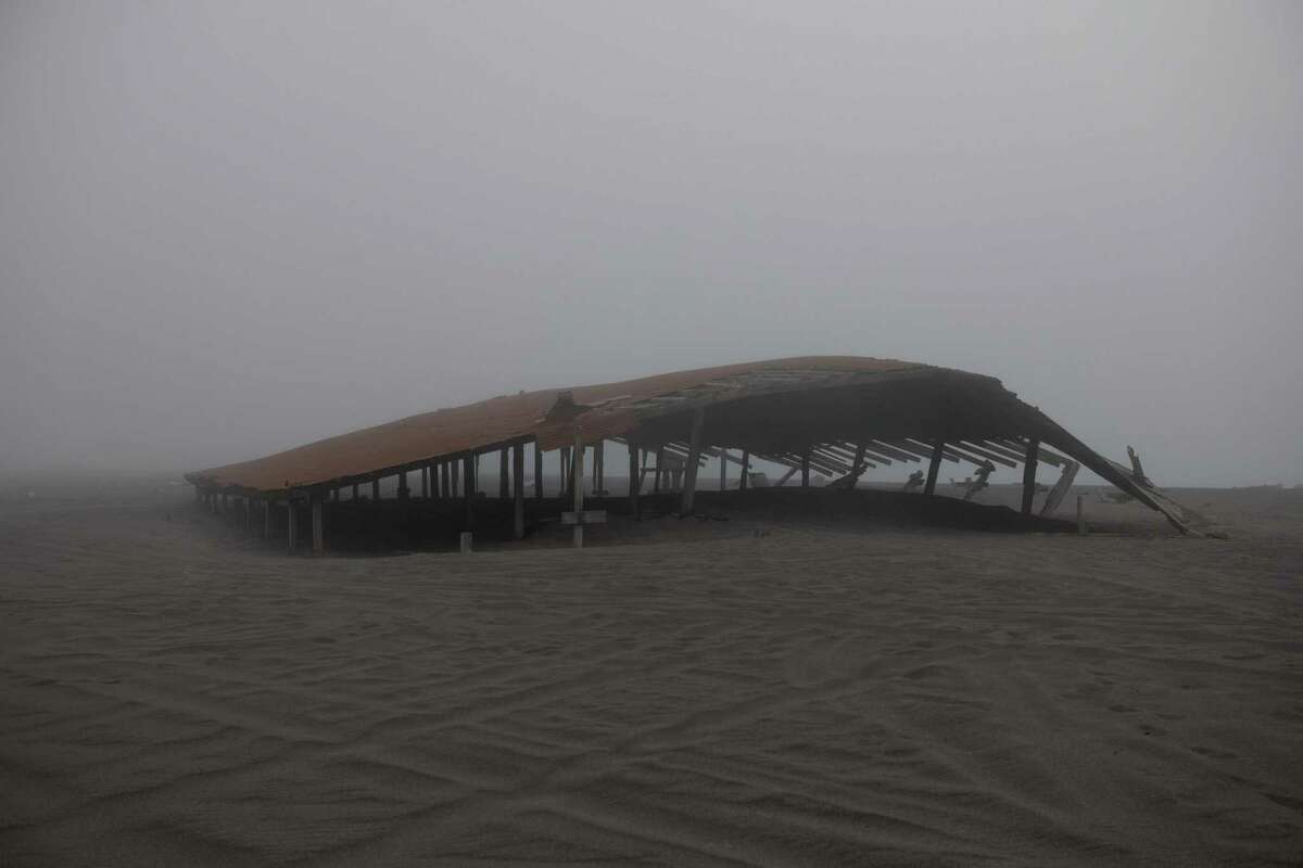 A barn on Centerville Beach has been battered and partially buried by the waves and the king tides in Ferndale (Humboldt County).