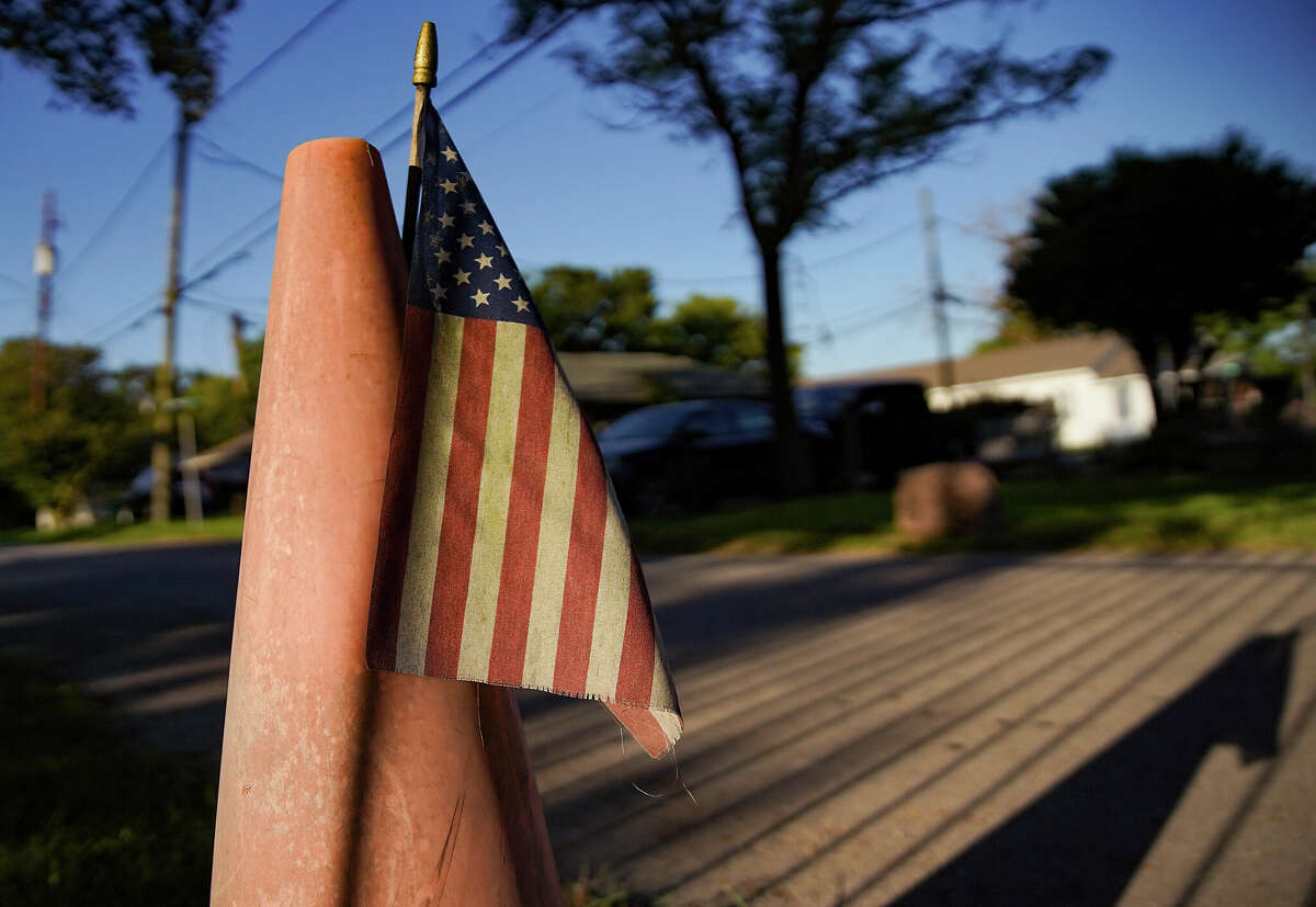 A U.S. flag sits on a cone near the home Joe Ballard grew up in on Wednesday, Sept. 28, 2022 in Houston.