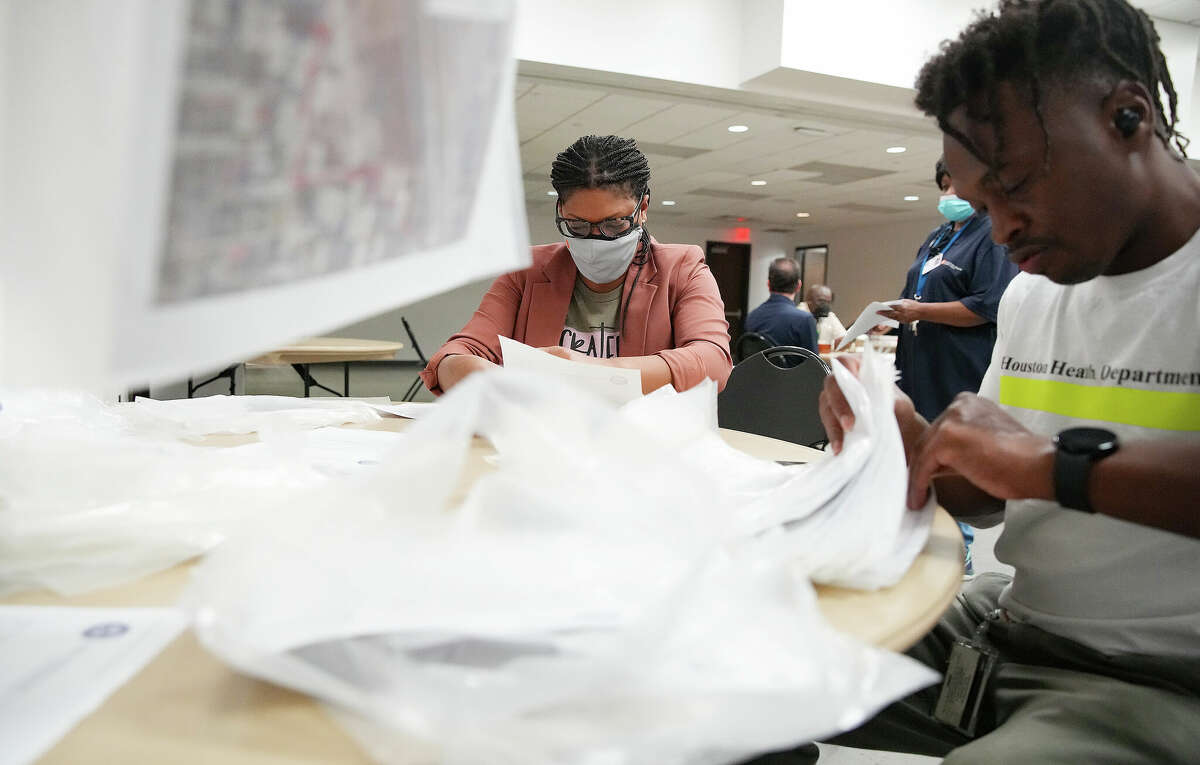 City of Houston Health Dept., employees, including Kaylan Henderson and Marcus Wilhite, sort flyers before passing they pass them out in a Fifth Ward neighborhood at Kashmere Multi-Service Center on Thursday, Sept. 29, 2022 in Houston. The department was passing out flyers from the EPA in neighborhoods where testing found dioxins in samples stemming from the Union Pacific rail yard.