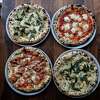 Benchmark Pizzeria’s favorite pizzas can be seen in their restaurant in Kensington, Calif. on Thursday, Feb. 24, 2022. The pizzas include fried sage, the Benchmark and salami and Calabrian chili.