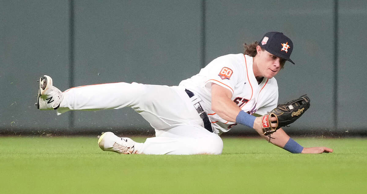 Houston Astros center fielder Jake Meyers (6) dives to catch Texas Rangers Corey Seager's line out during the seventh inning of an MLB baseball game at Minute Maid Park on Tuesday, Aug. 9, 2022 in Houston.