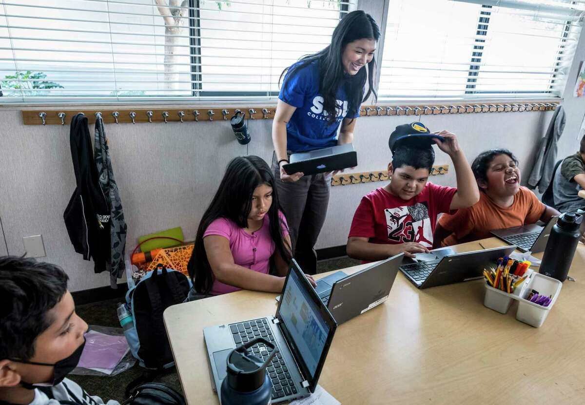 Veerawan Tontiwattananan, a first-generation San Jose State student from Dublin, works with students during a tutoring session for at Sherman Oaks Elementary in San Jose.