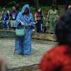 Mary Kimball presides over the fire ritual, which also features the element of water, represented by her blue robe.