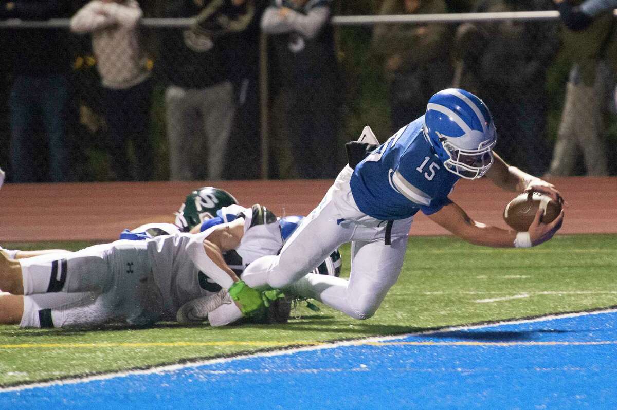 Shaker quarterback Jake Iacobaccio jumps with the ball into the end zone for his team’s first touchdown of the night against Shenendehowa during a game in Latham, N.Y. on Friday, Sept. 30, 2022. (Jenn March, Special to the Times Union)