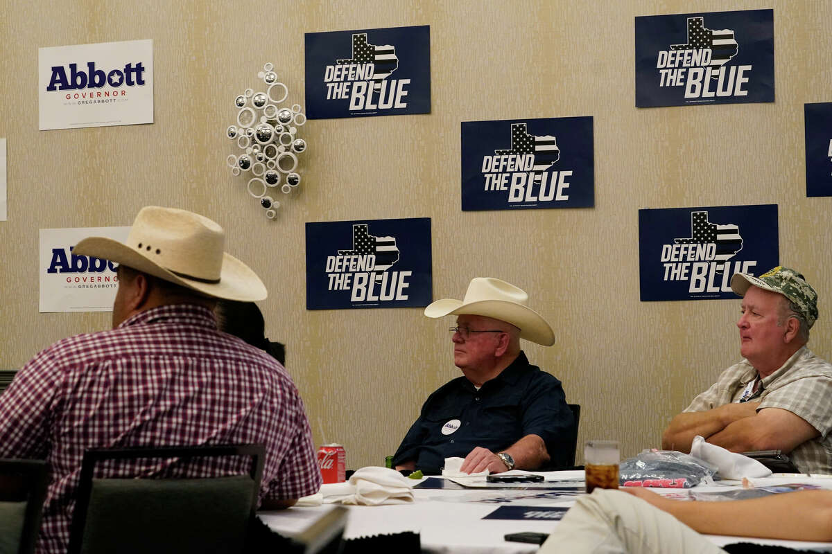 Supporters of Texas Gov. Greg Abbott watch his debate with Texas Democratic gubernatorial candidate Beto O'Rourke, Friday, Sept. 30, 2022, in McAllen, Texas. (AP Photo/Eric Gay)
