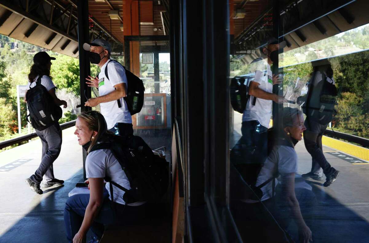 Chronicle Columnist Heather Knight, culture critic Peter Hartlaub and #TotalTransit22 route co-creator Hayden Miller (left) return to the Orinda BART Station after skipping a delayed County Connection bus in Orinda.