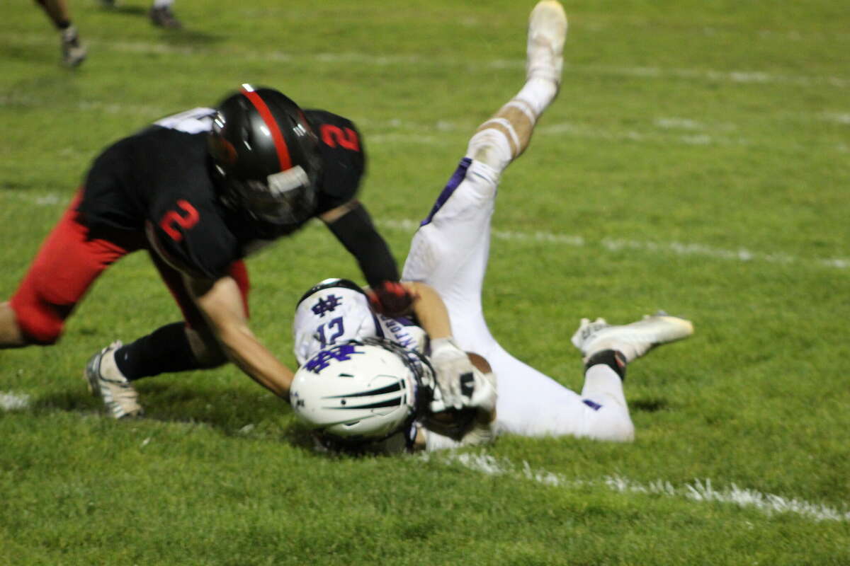 North Branford receiver Ian Kamienski is stopped short of a first down by the Panthers' Matt Gish in the fourth quarter of Friday night's game in Cromwell.