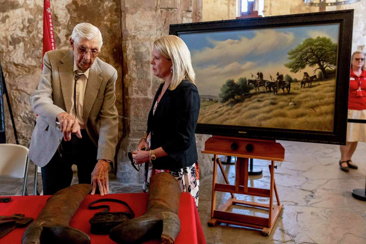 Longtime Bexar County collector Donald Yena talks with Kate Rogers, executive director of the Alamo Trust, as they stand with items recently purchased by the Texas General Land Office in the Alamo Church on Friday. The Yena collection is said to focus primarily on the pre-battle mission era of the Alamo’s history and is intended to help tell a complete story of the site’s 300 years of recorded history, including its role as the first permanent Indigenous mission community in San Antonio