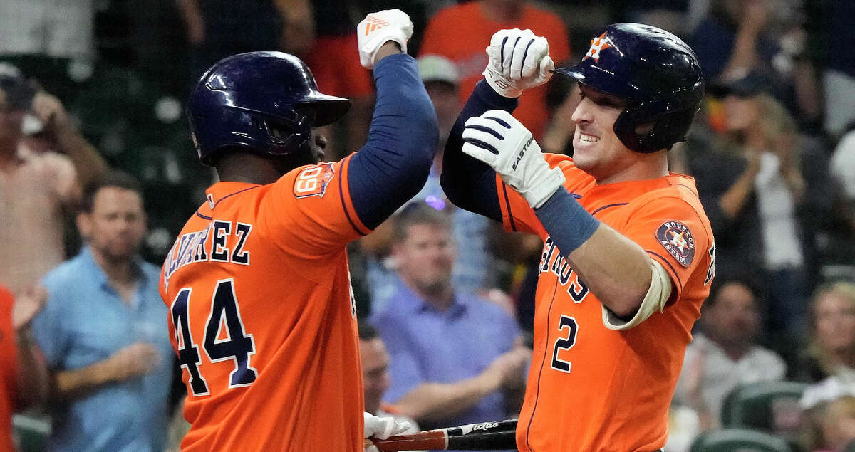 Houston Astros Alex Bregman (2) celebrates his home run with Yordan Alvarez (44) against Tampa Bay Rays starting pitcher Drew Rasmussen during the first inning of an MLB baseball game at Minute Maid Park on Friday, Sept. 30, 2022 in Houston.