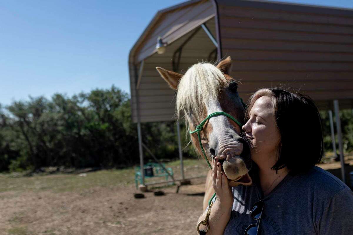 Sarah Trimble loves on Zeus, a horse she rescued and is working with, at her home in Hill Country in TX, on Sept. 22, 2022. Sarah really wants a child, but she's had three miscarriages in her past, and Texas' abortion laws and the reporting she'd read about pregnancy complications made more dangerous because of those laws are giving her pause. If the law and uncertainty remains, and as her biological clock ticks, she fears she may never have children.