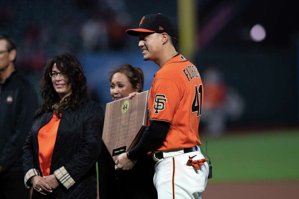 SAN FRANCISCO, CALIFORNIA - SEPTEMBER 30: Wilmer Flores #41 of the San Francisco Giants is presented with the 2022 Willie Mac Award before the game against the Arizona Diamondbacks at Oracle Park on September 30, 2022 in San Francisco, California.