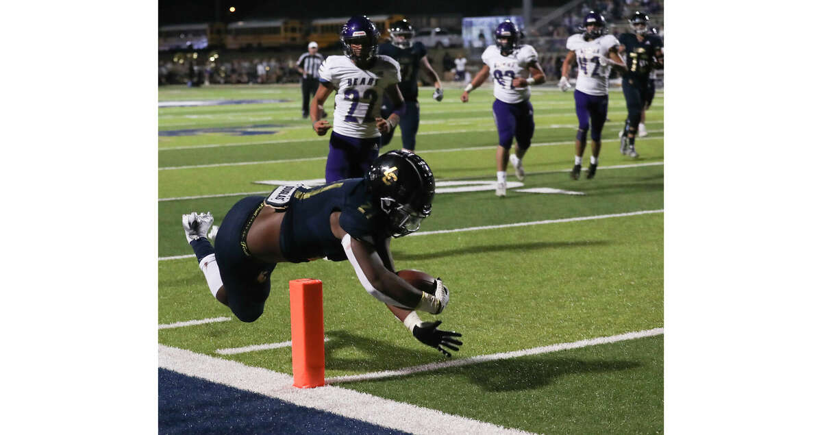 Lake Creek running back Tyvonn Byars (21) leaps toward the end zone to score a 19-yard touchdown in the fourth quarter of a District 10-5A (Div. II) high school football game at Montgomery ISD Stadium, Friday, Sept. 30, 2022, in Montgomery.