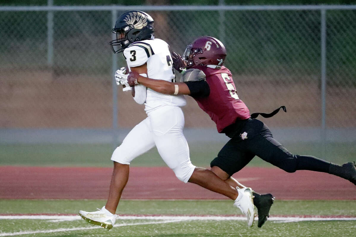 Foster receiver Kendal Stewart (3) drags Magnolia West defensive back Lance Thomas (6) into the endzone as he scores during the first half of their District 10-5A high school football game Friday, Sept. 30, 2022 in Magnolia TX.