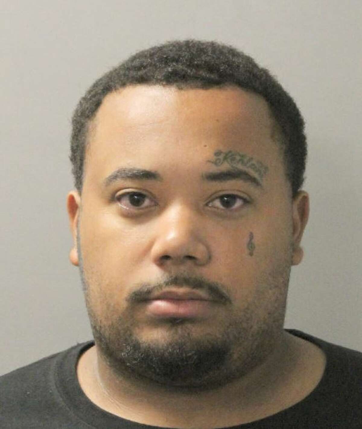 Police identified Charlie Guillory, 25, as a person of interest in a late Friday shooting that injured one man and killed a bystander in Fifth Ward. 