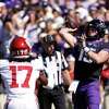 TCU quarterback Max Duggan (15) throws a touchdown pass as Oklahoma defensive back Damond Harmon (17) defends during the first half of an NCAA college football game Saturday, Oct. 1, 2022, in Fort Worth, Texas.