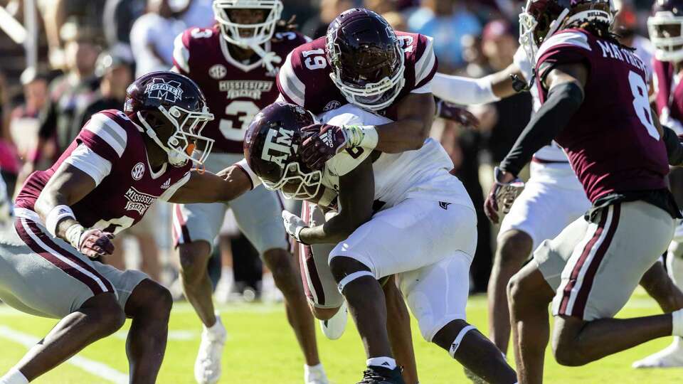 Mississippi State safety Collin Duncan (19) stops Texas A&M running back Devon Achane (6) during an NCAA football game on Saturday, Oct. 1, 2022, in Starkville, Miss. (AP Photo/Vasha Hunt)