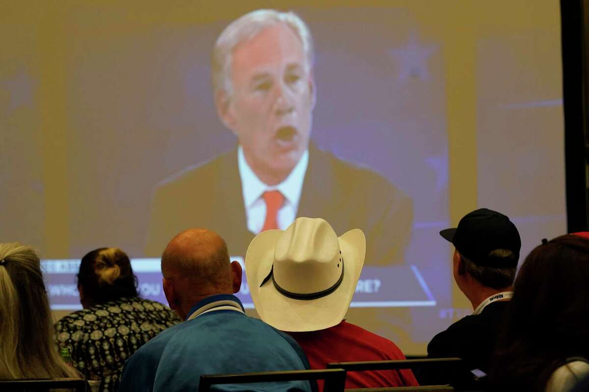 Supporters of Texas Gov. Greg Abbott watch his debate with Texas Democratic gubernatorial candidate Beto O'Rourke, Friday, Sept. 30, 2022, in McAllen, Texas. (AP Photo/Eric Gay)