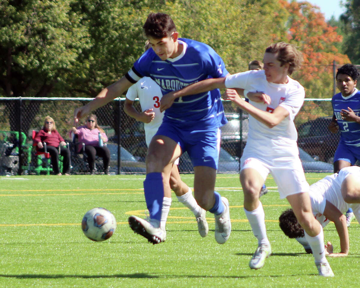 Marquette's Myles Paniagua, left, and Triad's Charlie Gentemann battle for the ball Saturday at Gordon Moore Park. Triad posted a 6-1 victory.