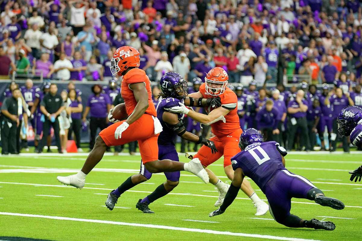 Sam Houston running back Dezmon Jackson, left, runs into the end zone for the game-winning touchdown during the second half of an NCAA college football game against Stephen F. Austin, Saturday, Oct. 1, 2022, in Houston.