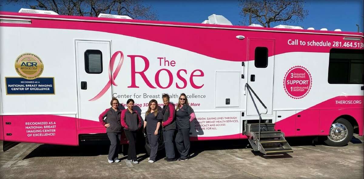 Staff members from The Rose pose in front of "Lilly," the nonprofit's fourth luxury mobile coach that debuted on Sunday, Jan. 13, 2022, in southwest Houston. The breast screening unit is expected to provide 2,500 mammograms to women across 41 Southeast Texas counties during its first year.