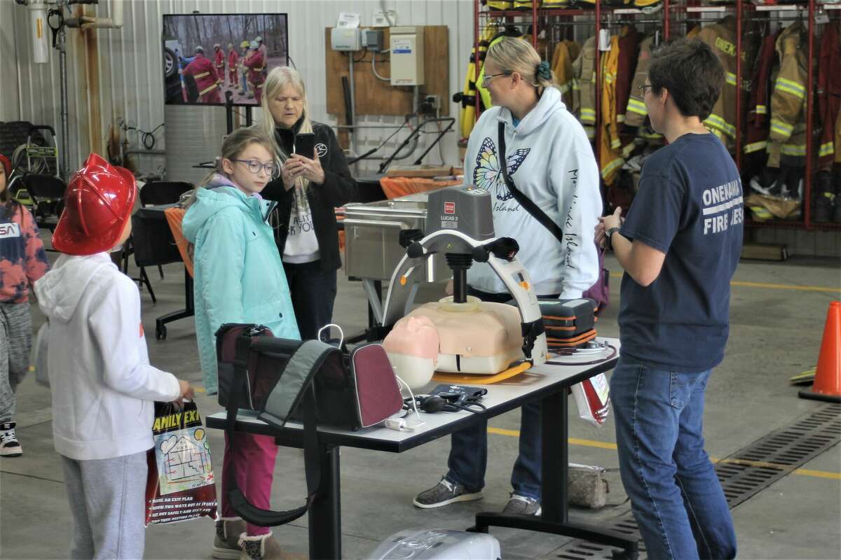 Attendees of the Onekama Township Fire Department open house event Saturday check out the Lucas, an automated chest compression machine.