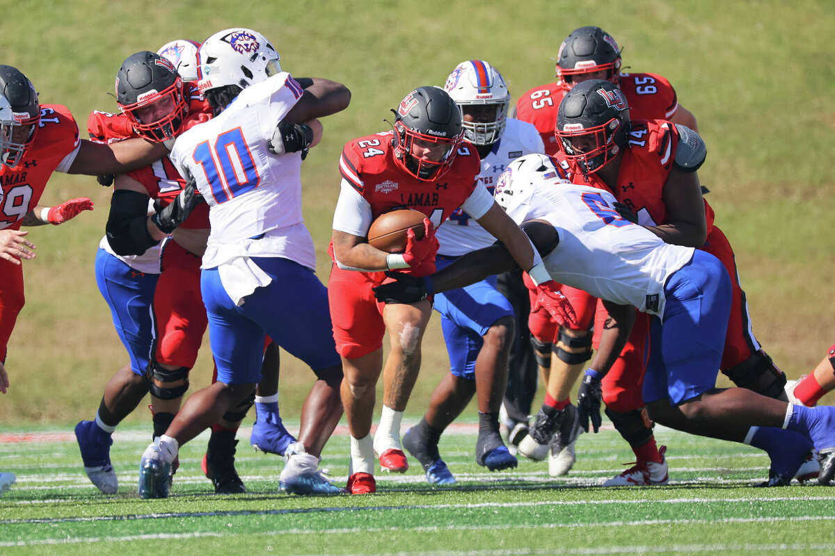 Lamar running back RJ Carver tries to avoid a tackle Saturday during the Cardinals homecoming game against HCU at Provost Umphrey Stadium.