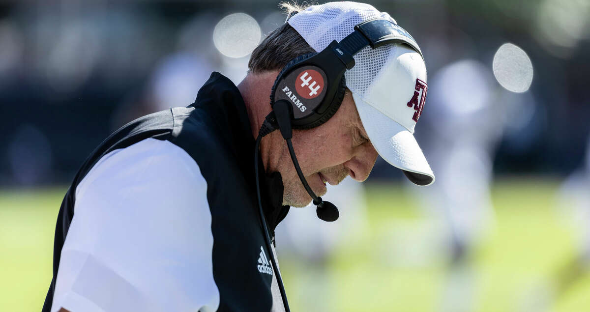 Texas A&M head coach Jimbo Fisher looks down between plays during an NCAA football game against Mississippi State, Saturday, Oct. 1, 2022, in Starkville, Miss. (AP Photo/Vasha Hunt)